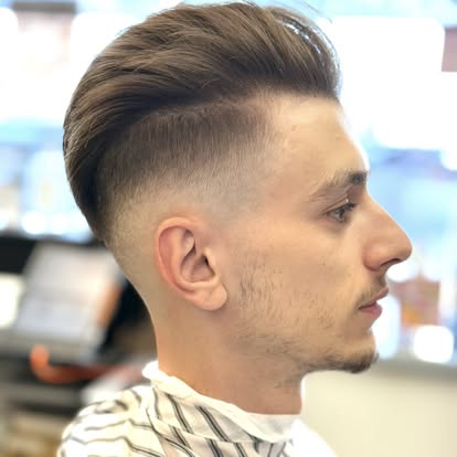 Skin fade with defined beard lineup.